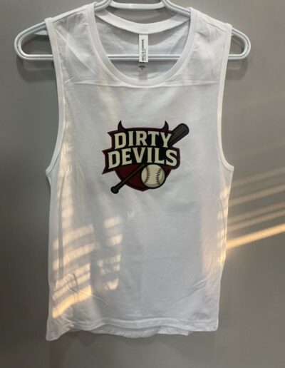 White sleeveless shirt hanging on a hanger, featuring a "Dirty Devils" logo with a baseball bat and ball design, against a plain gray background.